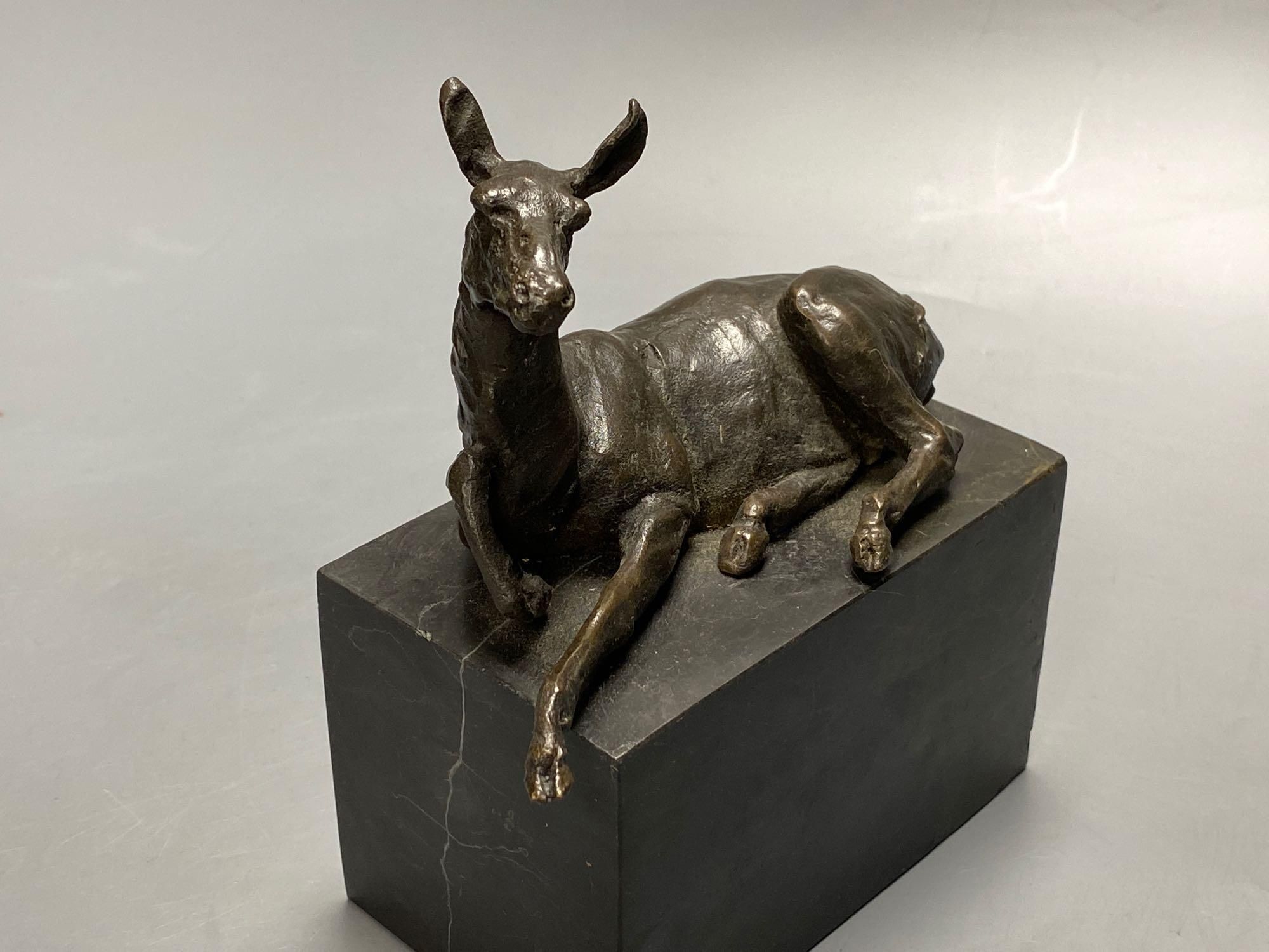 A bronze model of a recumbent mule, indistinctly signed, on marble plinth, width 12cm